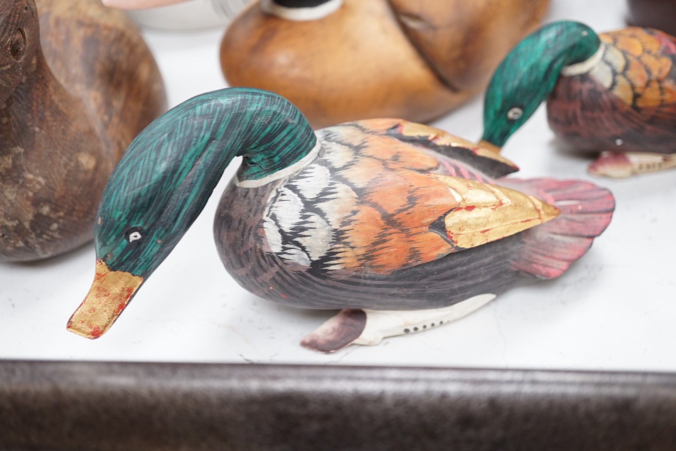 Nine carved wood decoy ducks